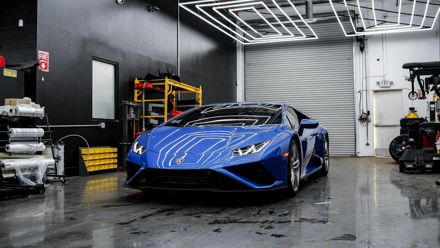 a blue huracan car in the garage