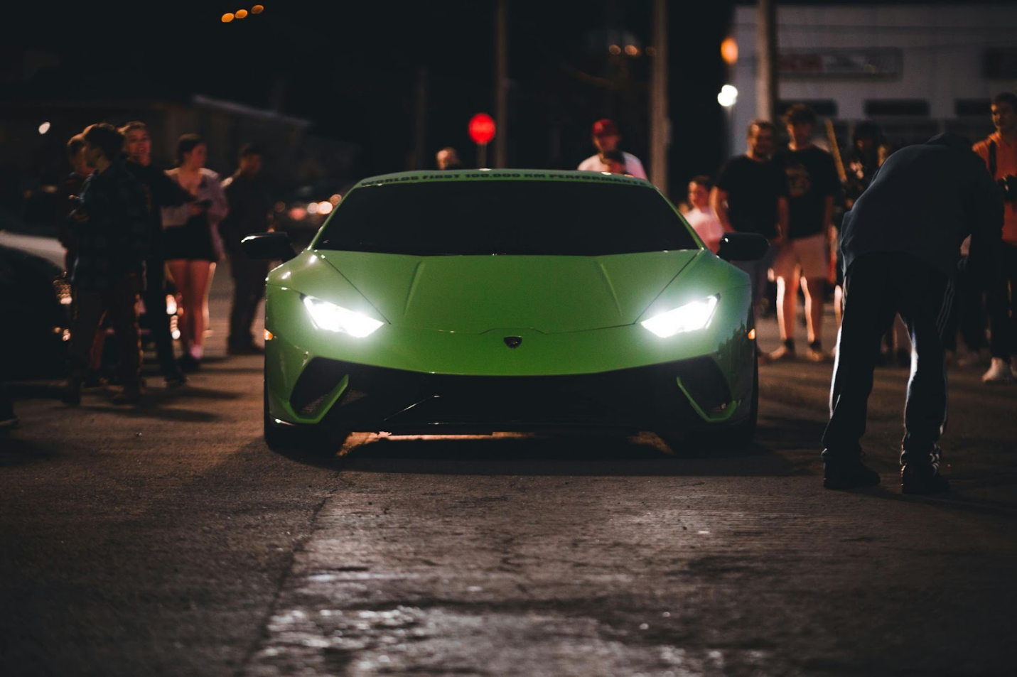 a green lamborghini huracan at night