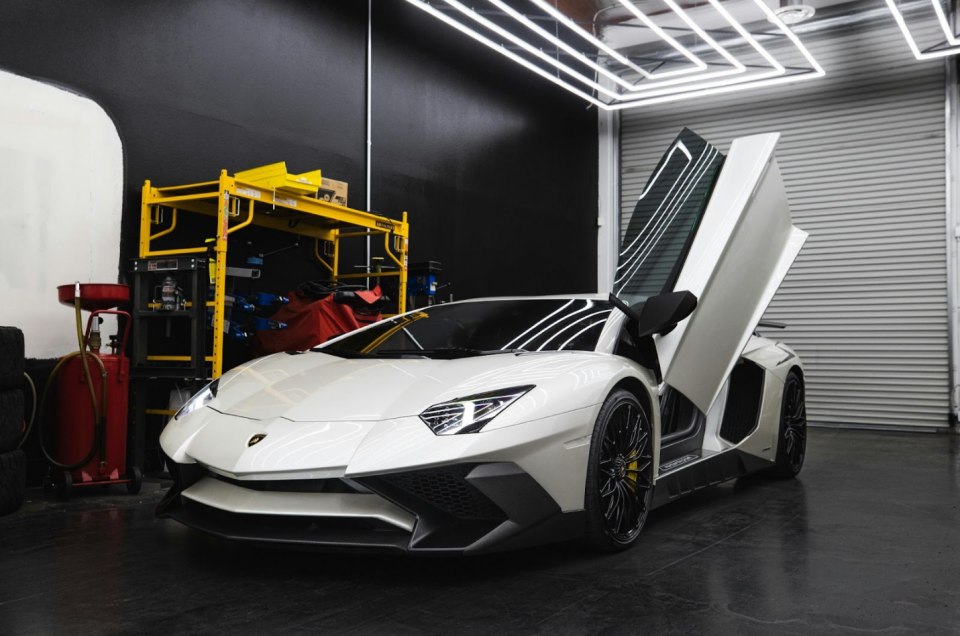 a white lamborghini car in the garage