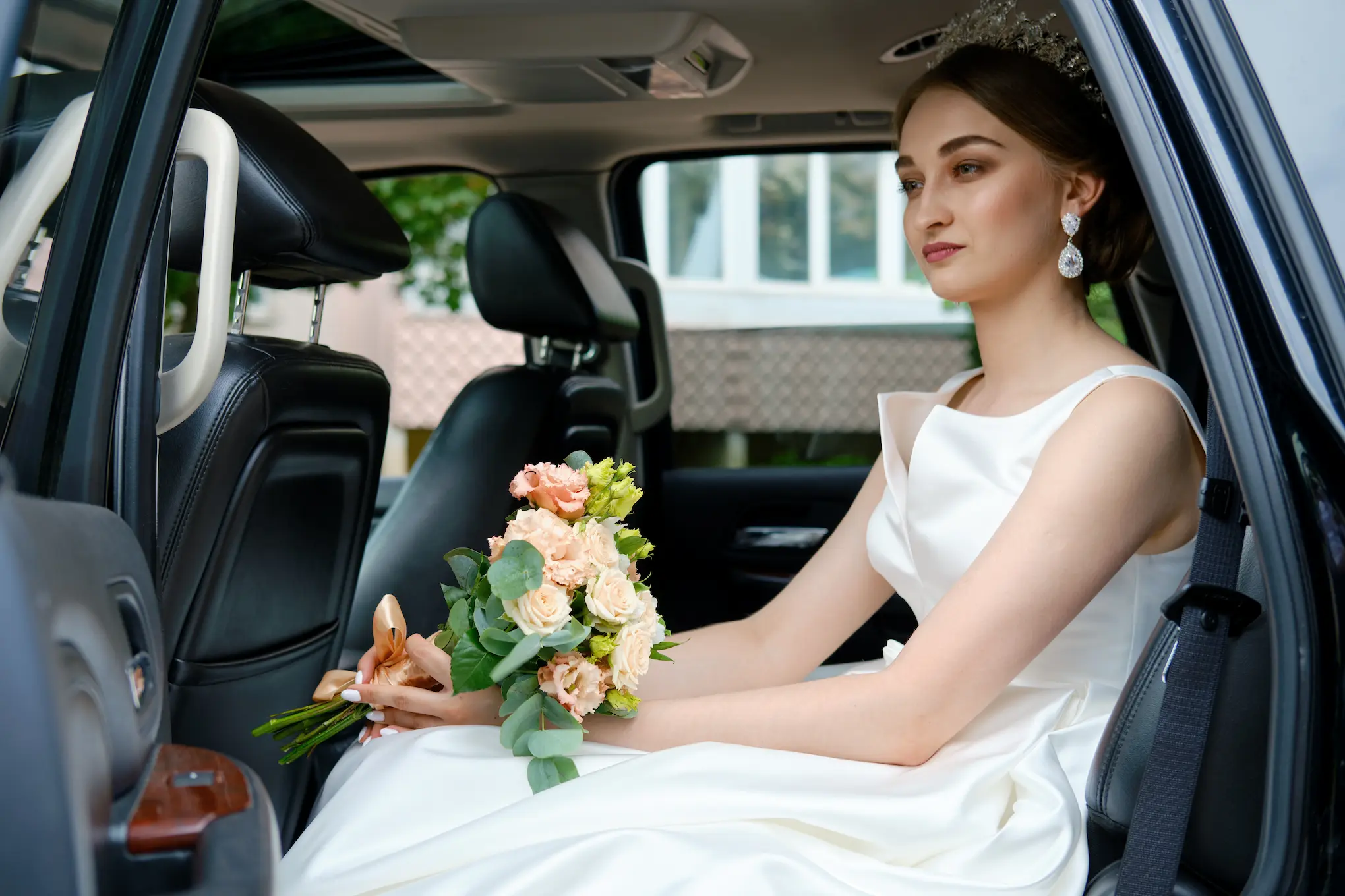 bride-sits-in-the-car-and-enjoying-the-comfort-of-a-luxury-car