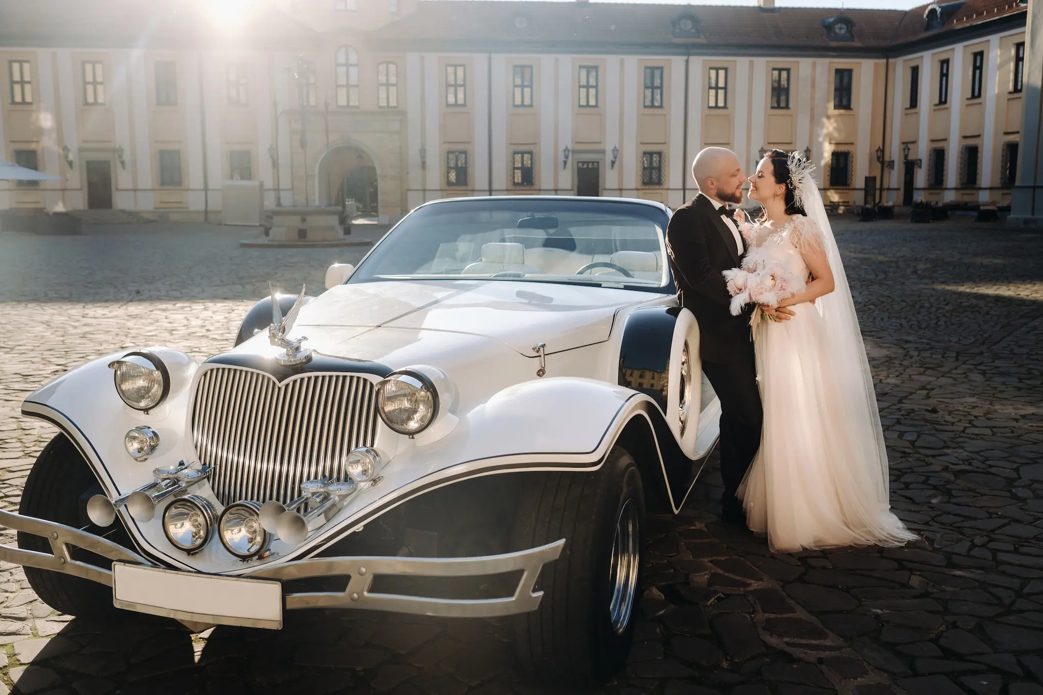 elegant-wedding-couple-beside-a-classic-car