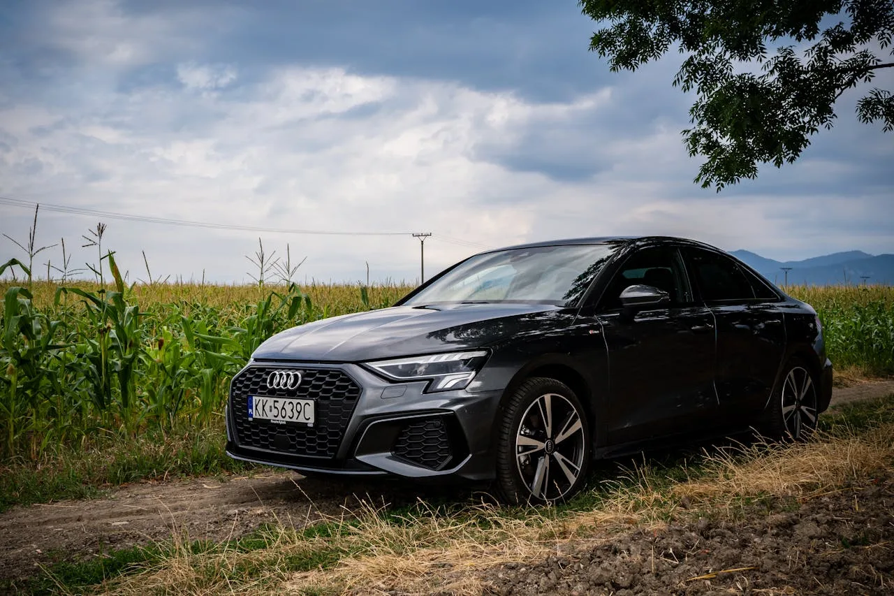 The audi a3 is parked on a dirt road